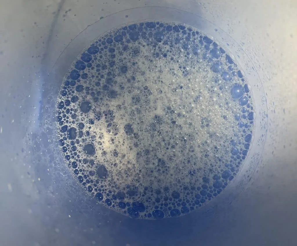 Blue bucket with sudsy water
