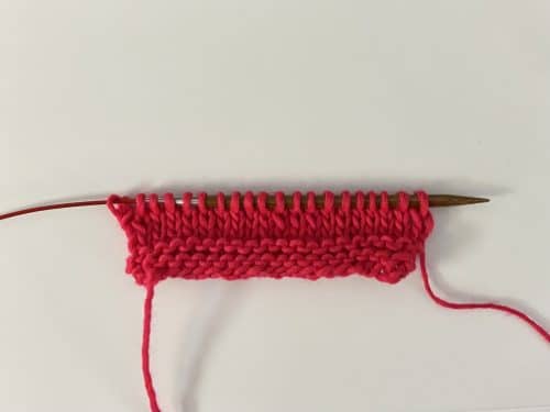 Cast On + 3 rows of garter stitch + 4 rows of stockinette Yarn: Manos del Uruguay Maxima in Speeding Ticket Needles: ChiaoGoo bamboo size 8 needles on a red cable.